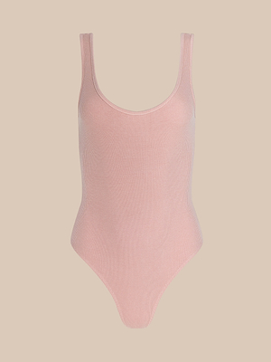 The Nica Scoopneck Bodysuit is light pink, sleeveless, and features a sculpted fit in high recovery stretch rib fabric with a scoop neckline and high-cut legs, displayed on a plain beige background.