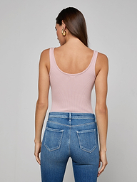 A woman is shown from the back, wearing the Nica Scoopneck Bodysuit in light pink, paired with blue jeans featuring visible back pockets, against a plain light background.