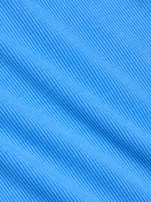 Close-up of textured blue fabric with diagonal ribbed lines, echoing the signature design of the Nica Scoopneck Bodysuit. Lighting enhances the ridges, adding depth and dimension to the material.