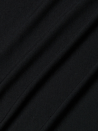 Close-up of the Remy Tee in black micro modal jersey fabric with diagonal folds and visible texture, highlighting its fine knit pattern and subtle shadows for a relaxed fit.