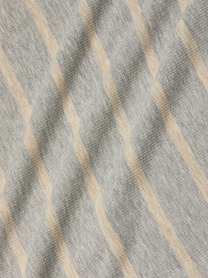 A close-up of the Nia Ribbed Tank’s light gray microfiber modal fabric, featuring thin beige diagonal stripes. The soft, slightly textured material has gentle folds, perfect for a comfortable racerback tank.