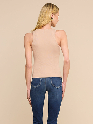 A person with long blonde hair is shown from the back, wearing the Adira Scoopneck Tank in ribbed stretch-cotton jersey and blue jeans, standing against a plain beige background.