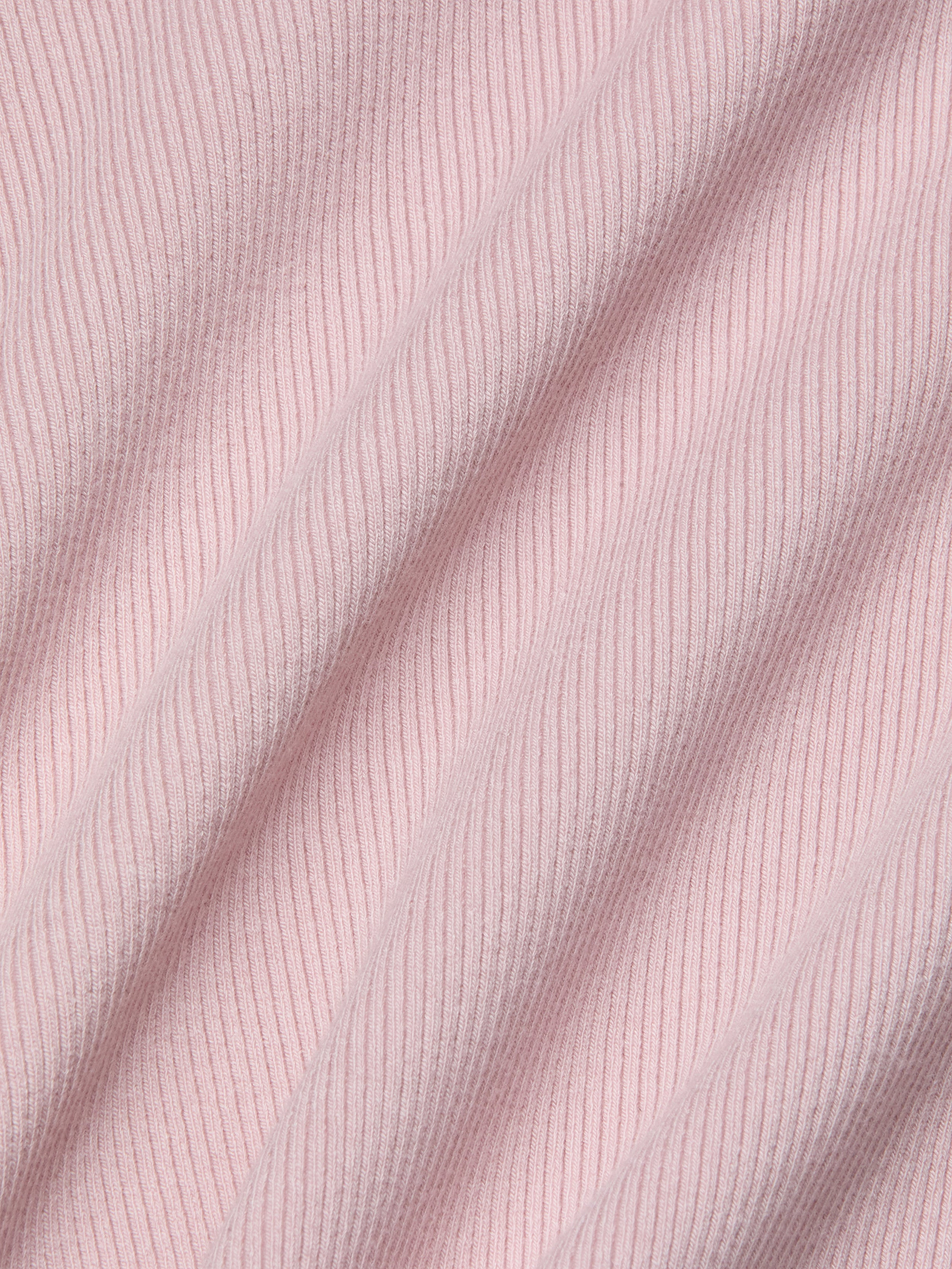 Close-up of the soft, stretch rib fabric in light pink on the Adira Scoopneck Tank, with diagonal folds highlighting the texture and pattern of the material.