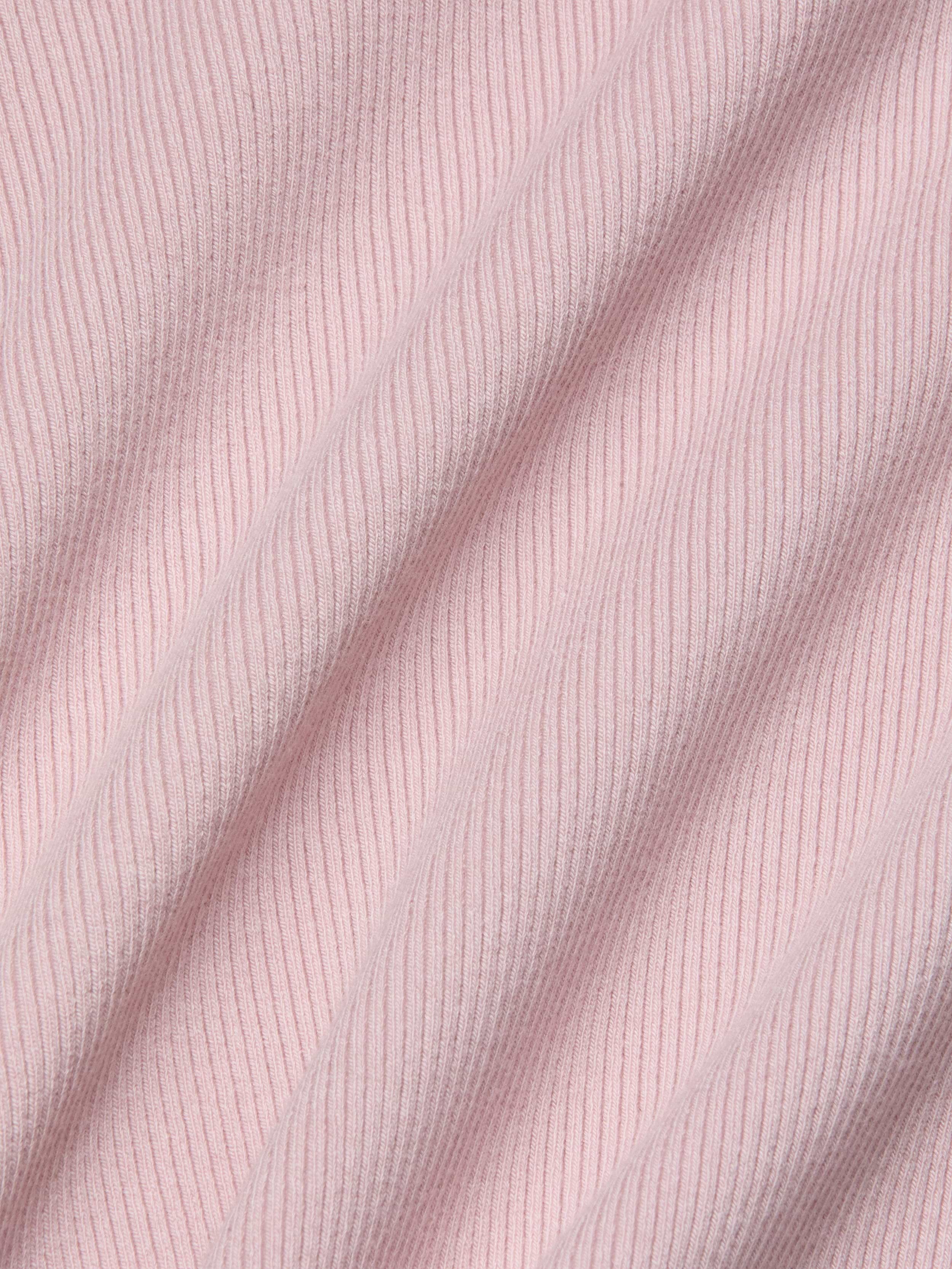 Close-up of the soft, stretch rib fabric in light pink on the Adira Scoopneck Tank, with diagonal folds highlighting the texture and pattern of the material.
