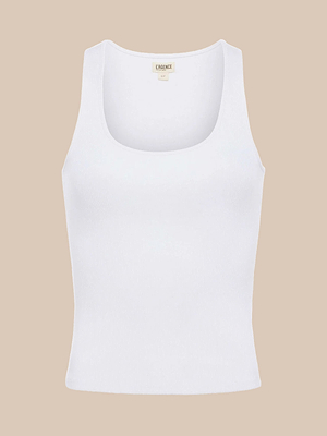 The Adira Scoopneck Tank is a white slim fit top with a ribbed texture and scoopneck, shown against a beige background. The collar label reads LA SERENE.