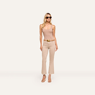 Woman wearing sunglasses, the Adira Scoopneck Tank in organic cotton, beige belted pants, and heeled sandals stands against a plain light background, looking forward with hands by her sides.