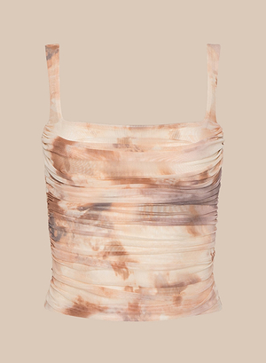 The Rasha Shirred Mesh Tank is a sleeveless women’s crop top with wide straps, ruched detailing, and a square neckline, featuring beige and brown tie-dye, shown on a plain beige background.