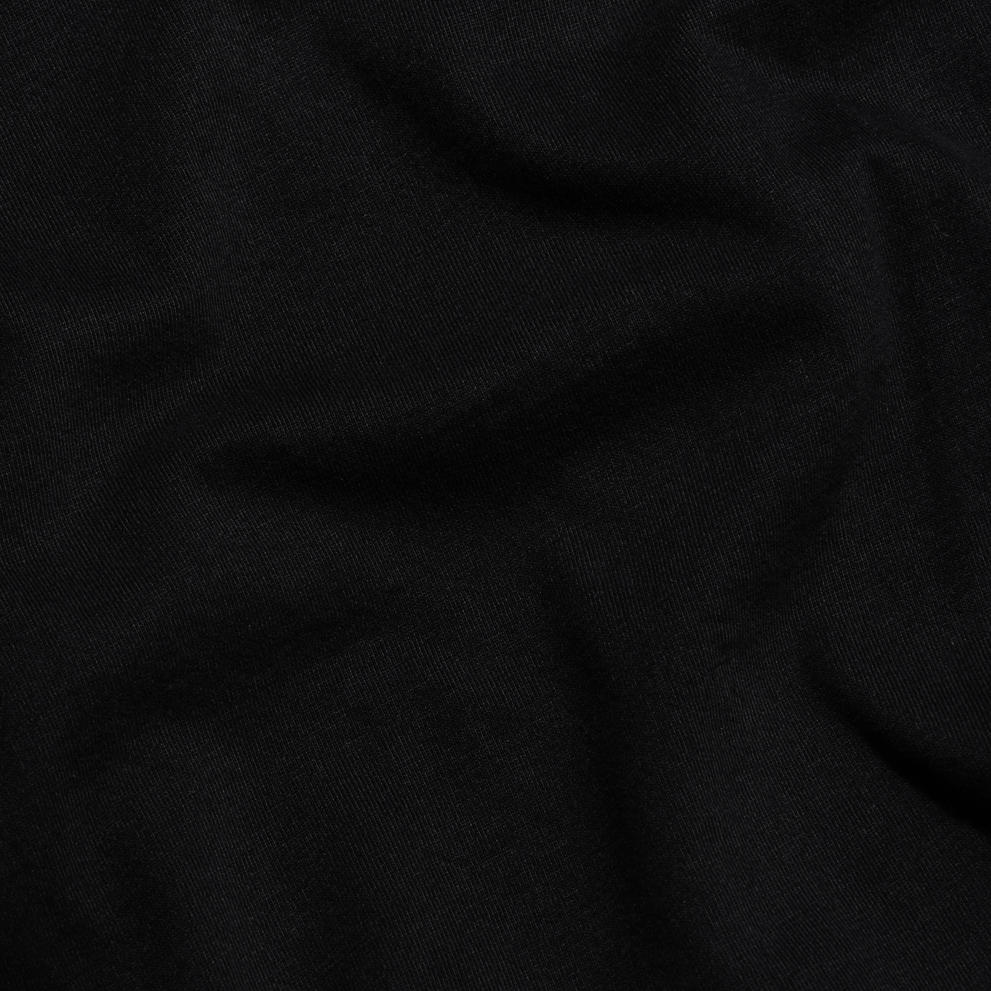 Close-up of soft folds in the black Supima cotton fabric of the Daria Oversized Cropped Tee.