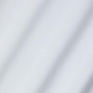 A close-up of the white fabric from the Daria Oversized Cropped Tee, crafted from soft Supima cotton in a relaxed fit, featuring visible texture and subtle diagonal shadows.