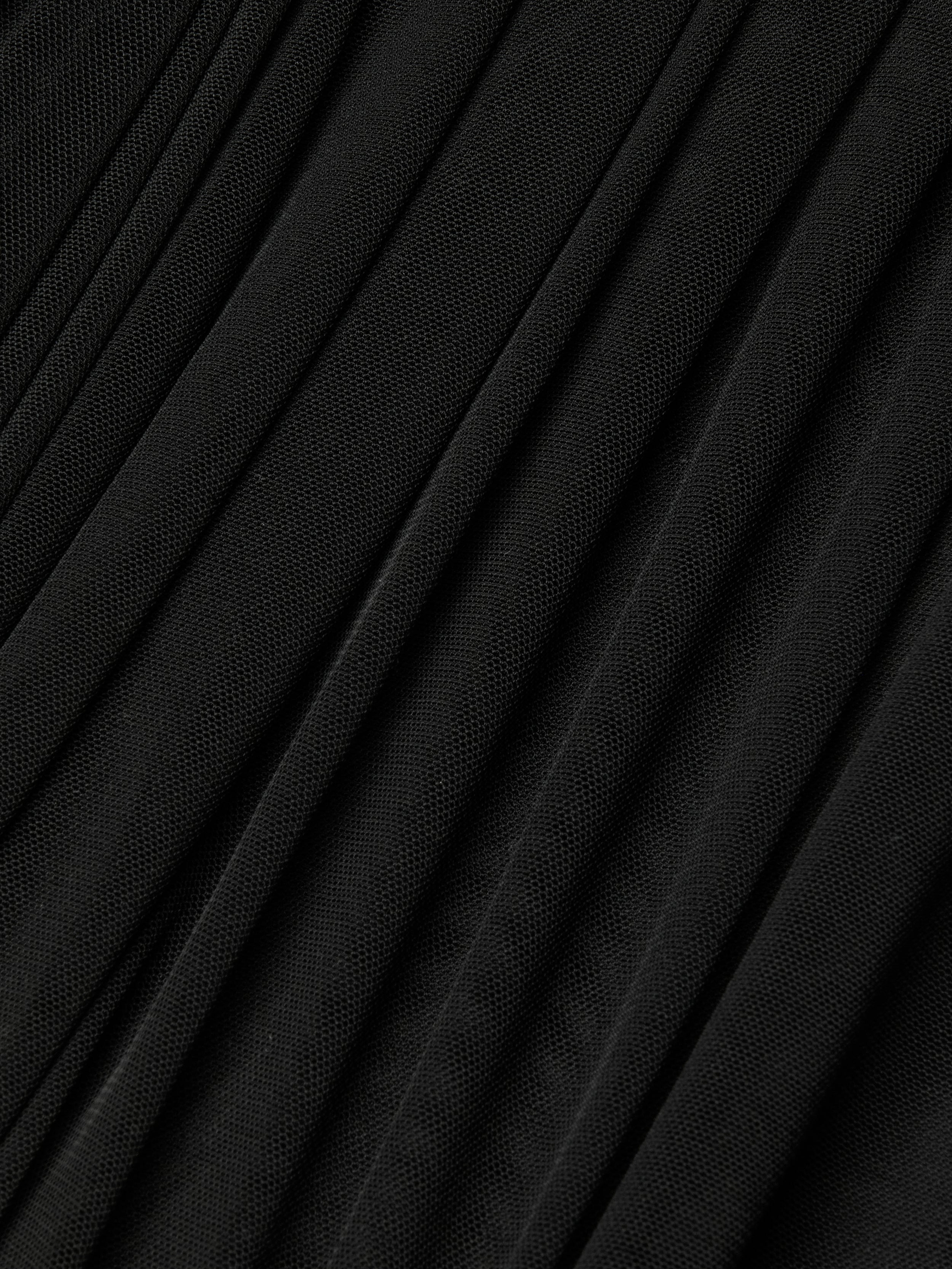 Close-up of the Poppie Off-The-Shoulder Bodysuit in black, featuring finely pleated fabric with a subtle stretch mesh texture and diagonal, evenly spaced folds for a sleek, sculpted look.