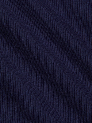Close-up of L'AGENCE's Elara Scoopneck Bodysuit in dark blue ribbed stretch cotton modal, featuring vertical textured lines and soft waves that highlight its signature body-contouring fit.
