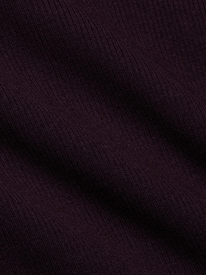 Close-up of dark ribbed fabric with diagonal ridges, highlighting the soft texture and deep, rich color of the L'AGENCE Elara Scoopneck Bodysuit.