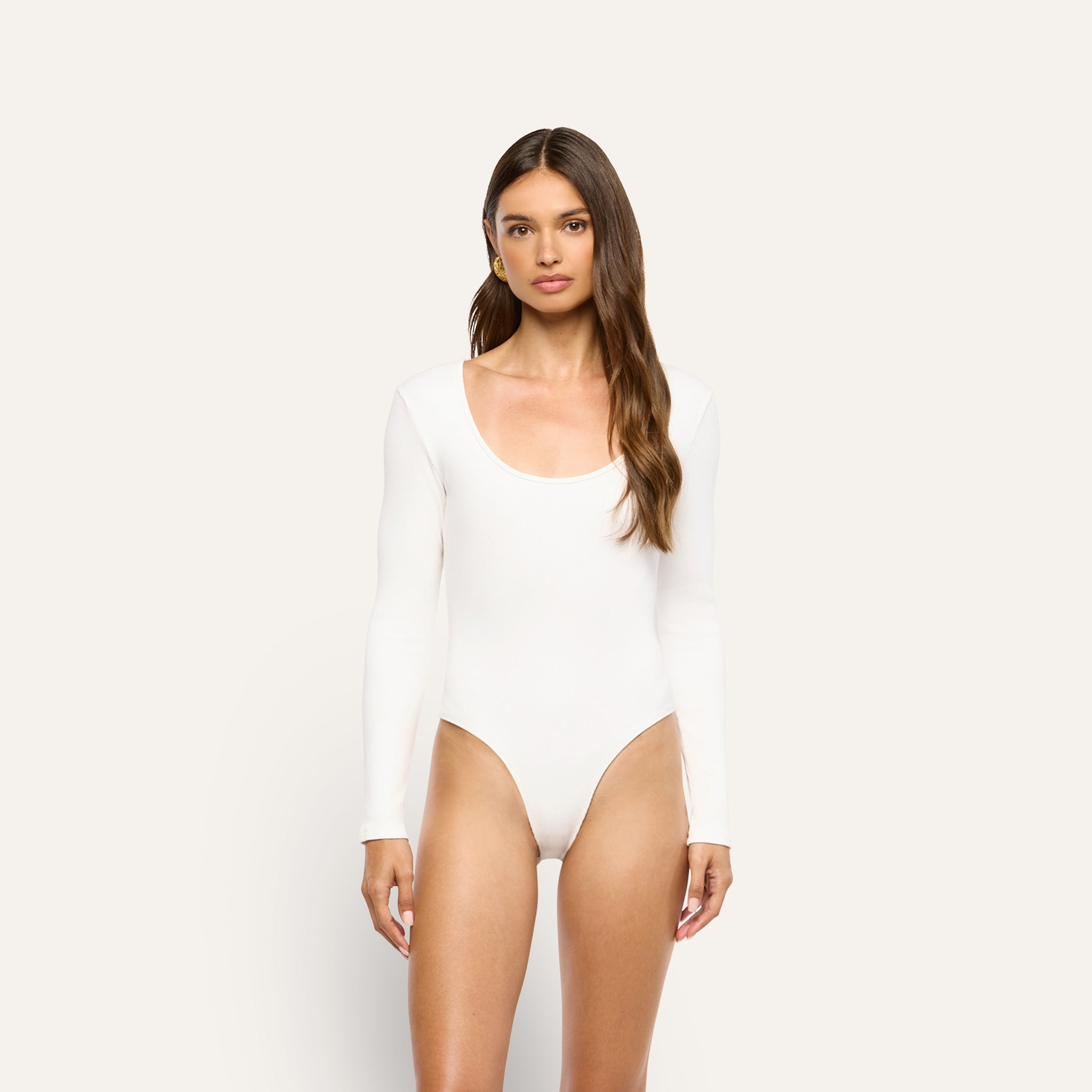 Elara Scoopneck Bodysuit in white, featuring a long-sleeved, scoopneck design in stretch cotton perfect for layering.