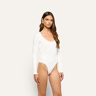 A person wearing the white, long-sleeved Elara Scoopneck Bodysuit in soft stretch cotton.