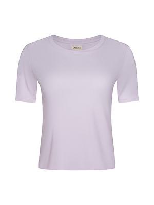 The Stormy Cropped Cotton Tee, made from organic cotton in light purple, is shown on a white background. It has a round neckline and a simple, fitted yet semi-relaxed design for comfortable everyday wear.