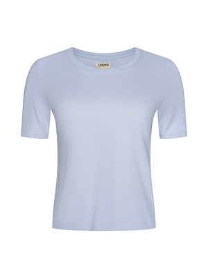 The Stormy Cropped Cotton Tee is a light blue, short-sleeve crew neck made from organic cotton and shown on a plain white background. This tee offers a simple, classic cropped design with a subtle neckline label.