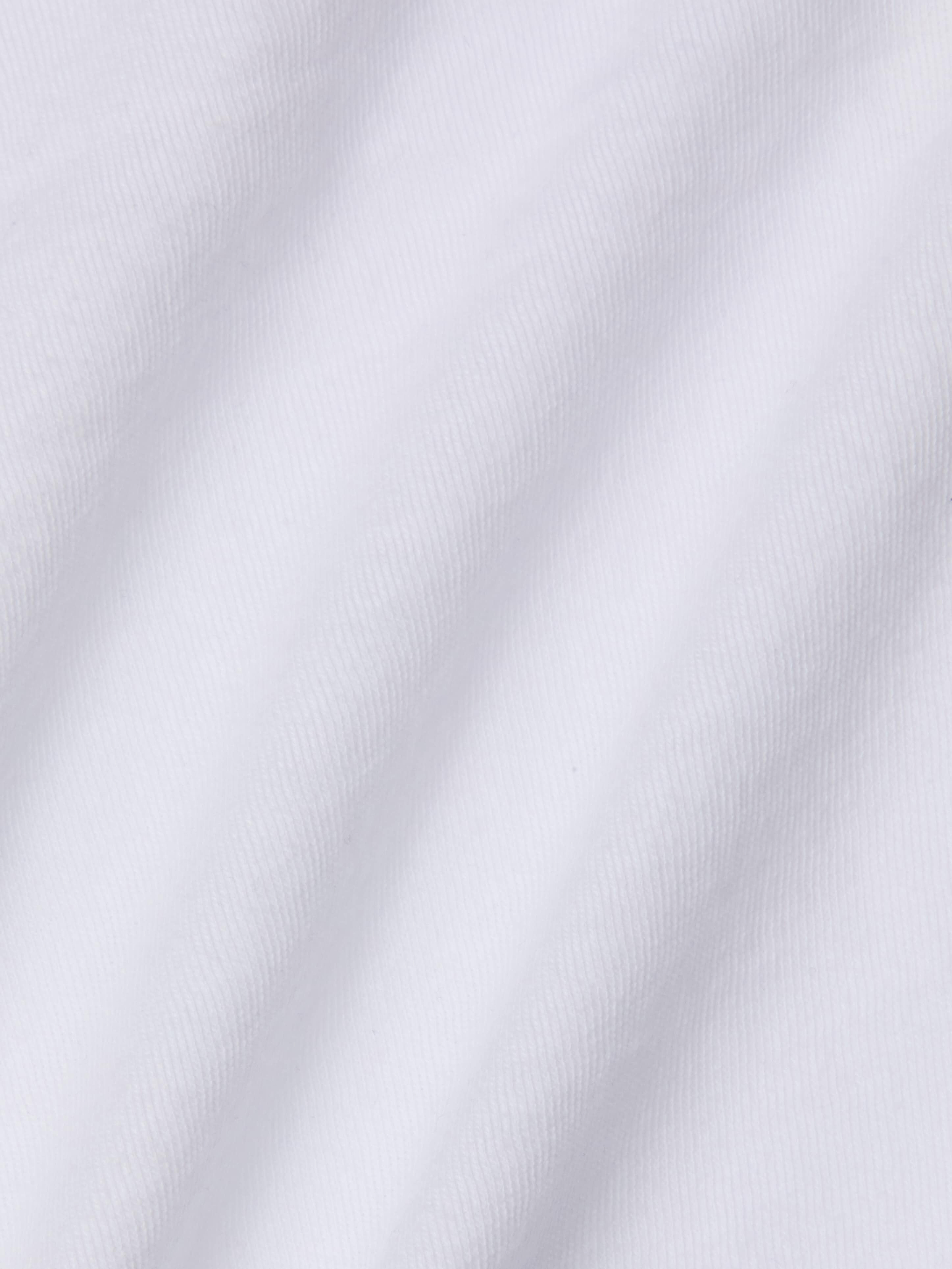 Close-up of the Stormy Cropped Cotton Tee made from organic cotton, featuring a white fabric with visible diagonal woven texture and gentle folds that display soft shadows and highlights.
