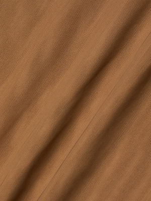 Close-up of the Kalea Mesh Bodysuit in light brown sheer stretch mesh, featuring a subtle textured pattern and gentle diagonal folds that cast soft shadows across its lightweight layer.