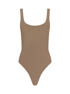The Kalea Mesh Bodysuit features a tan ribbed design with a square neckline and high-cut legs, styled as a lightweight layer and shown against a white background.