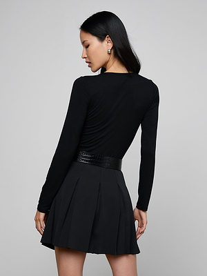 A woman wearing the Cassandra Ruched Bodysuit.