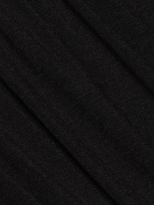 A close-up of the Cassandra Ruched Bodysuit's black fabric, ideal for a sleek long sleeve top or as a versatile base layer with a scoop neckline.