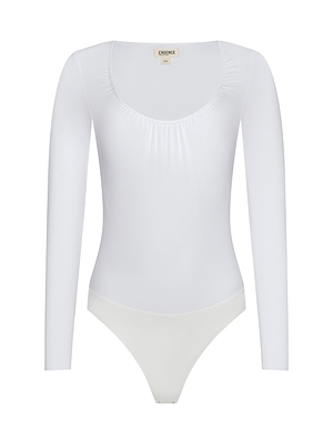 The Cassandra Ruched Bodysuit is a white, long sleeve top with a scoop neckline and fitted silhouette, ideal as a base layer. Shown on a plain white background.