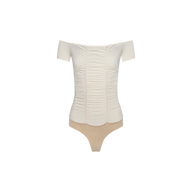 The Baliegh Ruched Bodysuit is an off-the-shoulder, vintage-inspired white top with short sleeves, delicate scalloped edges, and flattering ruching. It features a beige thong bottom and is displayed on a plain white background.