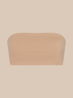 The Mietta Knit Bandeau Top, a plain strapless nude bandeau, is centered on a solid beige background, offering an understated and supportive fit.