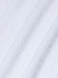 Close-up of smooth, white rib fabric with soft diagonal folds and a fine weave, highlighting the gentle texture and shadows that evoke the look and feel of the Wrenna Racerback Bodysuit.