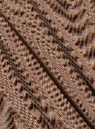 Close-up of the Thalassa High-Leg Bodysuit’s light brown mesh fabric with diagonal folds, highlighting its fine net-like texture and subtle shadows.