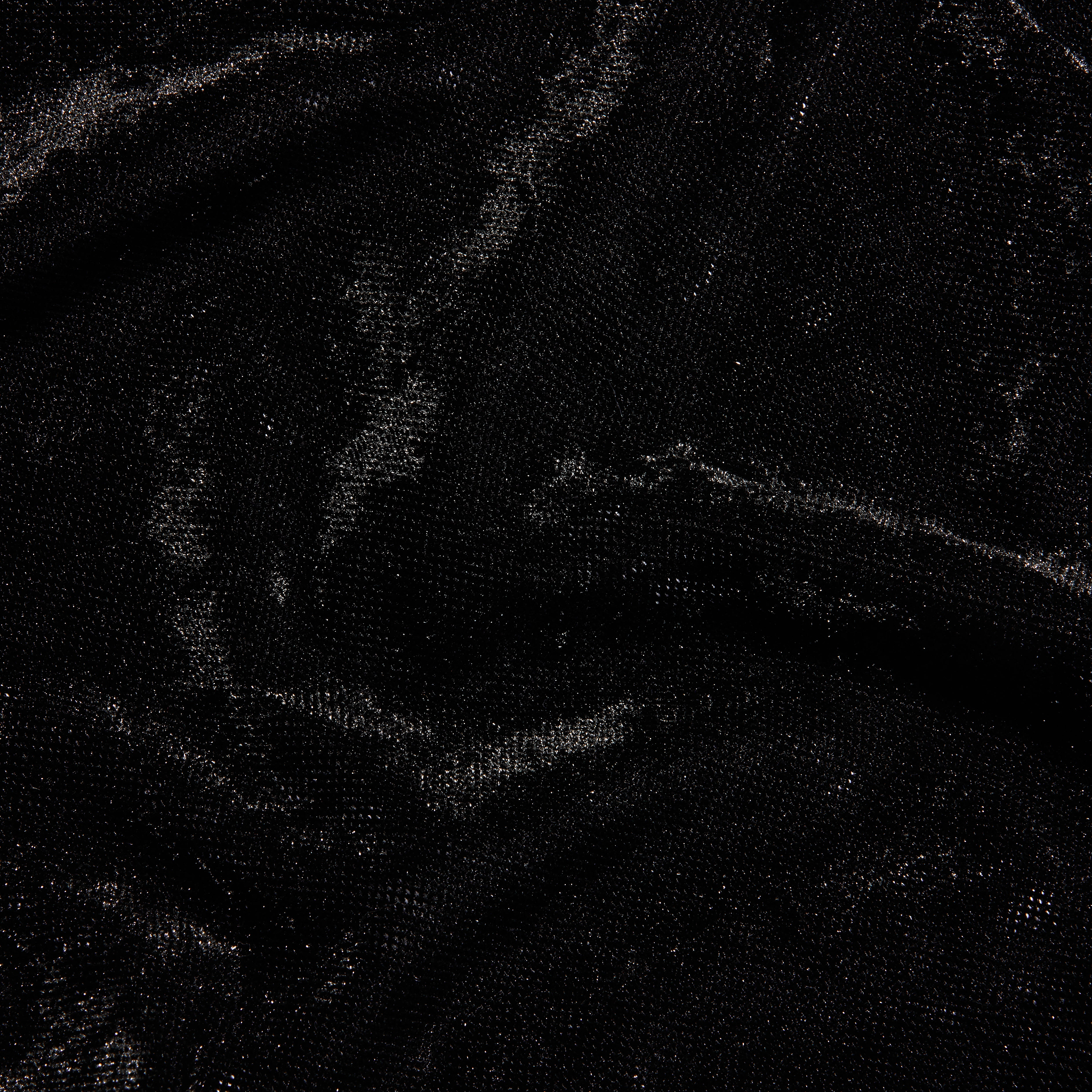 Close-up of a black Thalassa Velvet Mesh Bodysuit with a shimmering velvet and mesh texture.