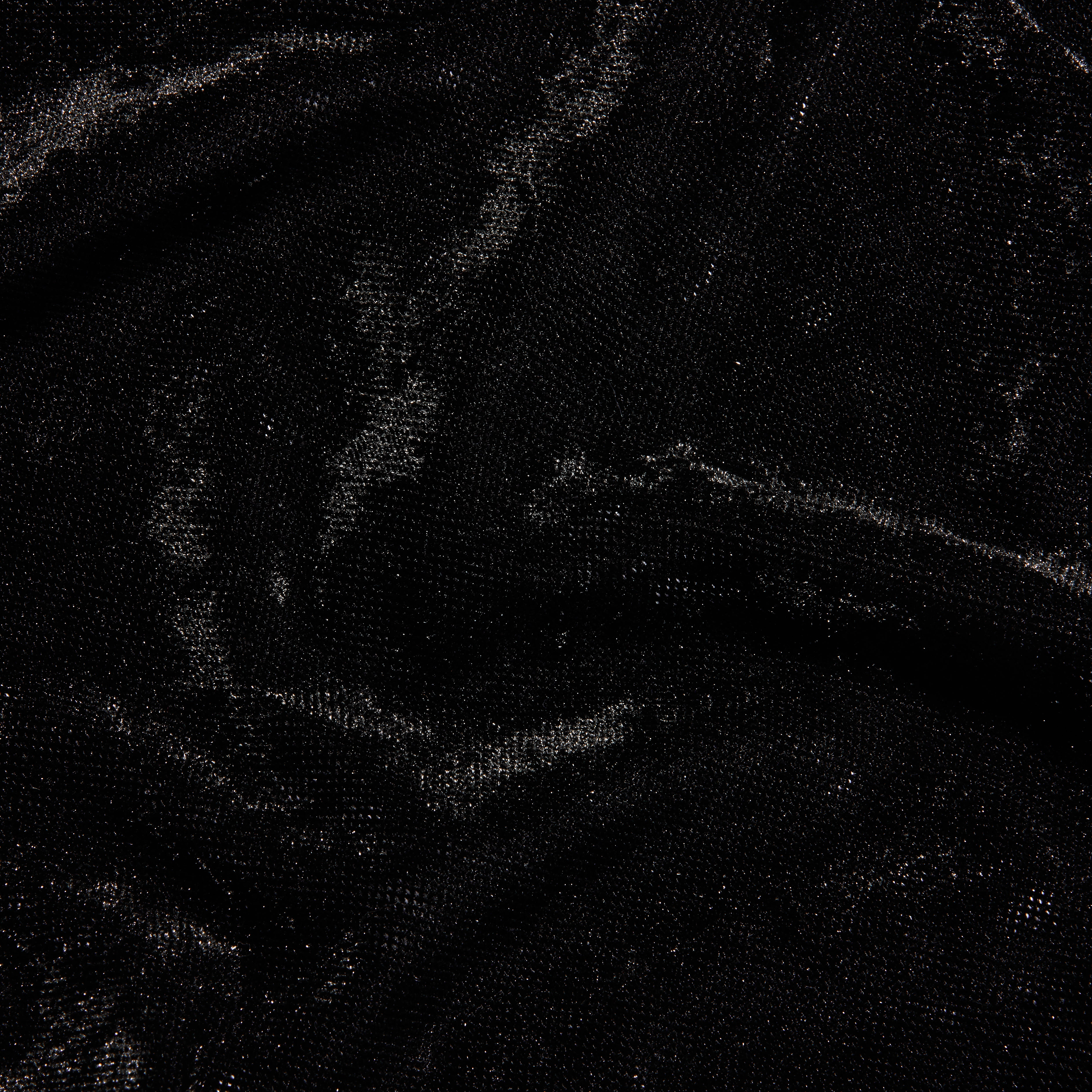 Close-up of a black Thalassa Velvet Mesh Bodysuit with a shimmering velvet and mesh texture.