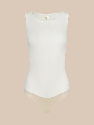 Sleeveless, white Riza Boatneck Bodysuit with a boat neckline and high-cut legs, made from soft stretch jersey and shown against a plain beige background.