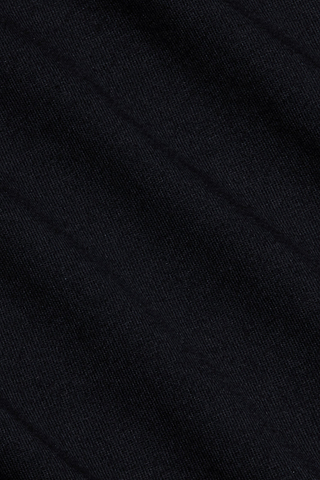 Close-up of a black textured fabric with subtle diagonal lines and shadows, displaying fine woven fibers and a soft surface pattern—crafted from luxurious Supima cotton, as featured in the Brianna Cotton V-Neck Tee.