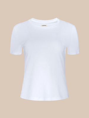The Aileen Cotton Crewneck Tee is a plain white Supima cotton top featuring short sleeves and a round neckline, shown against a beige background.