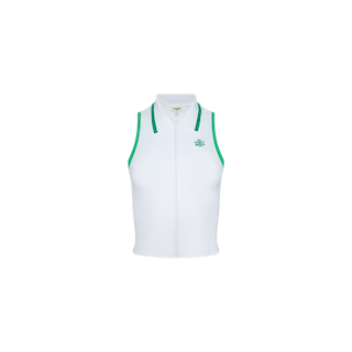 The Monica Tennis Polo is a sleeveless white tennis shirt with green trim on the armholes and collar, accented by a small green logo on the left chest. Made from breathable fabric, this sport-inspired top is shown against a plain white background.