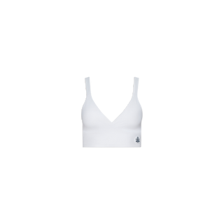 The Steffi Tennis Bralette is shown against a plain white background. This white sports bralette features wide straps, a deep V neckline, and is crafted from performance fabric. A small dark logo appears near the bottom hem on the left side.
