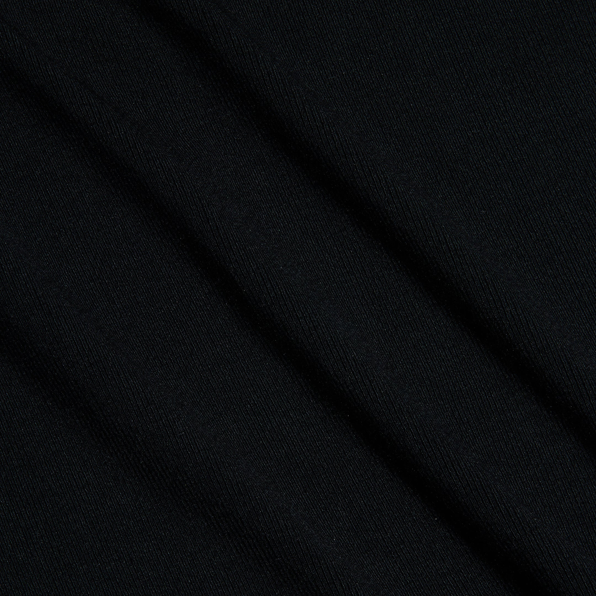 Close-up of black ribbed knit fabric seen at a diagonal angle, highlighting its subtle texture and fine parallel lines across the surface—the perfect choice for the Shania Racerback Tank.
