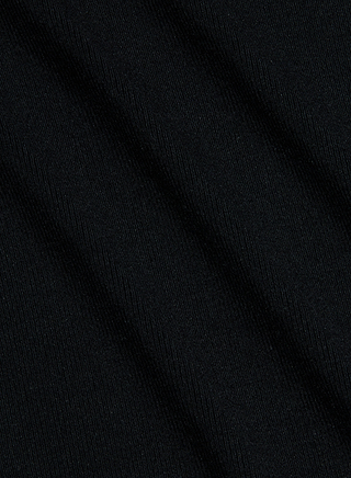 Close-up of black ribbed knit fabric seen at a diagonal angle, highlighting its subtle texture and fine parallel lines across the surface—the perfect choice for the Shania Racerback Tank.
