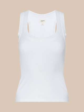 The Shania Racerback Tank, a white ribbed knit top featuring a scoop neckline, is displayed against a beige background. The fabric looks lightweight and comfortable.