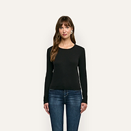 A woman wearing a black long-sleeved Leanne Cotton Tee and blue jeans.