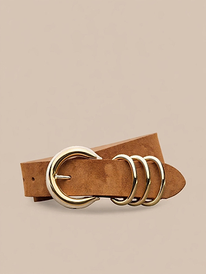 The Tobar Suede Belt, featuring cognac suede, a gold-plated buckle, and three gold rings, is displayed coiled on a neutral beige background.