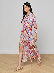 A woman wearing the Cameron Silk Shirt Dress and heeled sandals walks confidently against a plain white background.