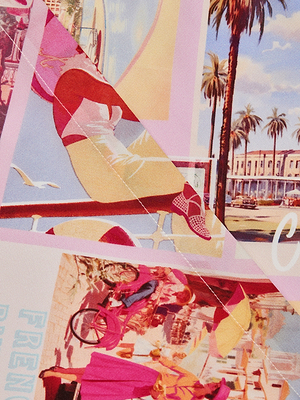 A vibrant postcard-style collage shows a person in the Cameron Silk Shirt Dress relaxing by a railing, with palm trees, pastel buildings, and a busy street cyclist in lively pink, yellow, and blue retro hues.