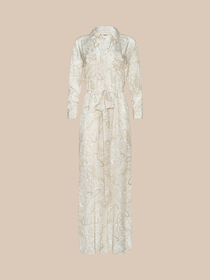 The Cameron Silk Shirt Dress is a long-sleeved, full-length dress with a collar, button-down front, chest pockets, tie waist belt, and features a light beige paisley print on matching beige silk.