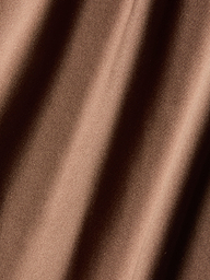 Close-up of the Serita Silk Gown, showcasing its brown silk fabric with soft diagonal folds and a lustrous, light-reflecting finish—an elegant choice for wedding guests.