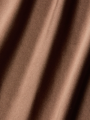Close-up of the Serita Silk Gown, showcasing its brown silk fabric with soft diagonal folds and a lustrous, light-reflecting finish—an elegant choice for wedding guests.