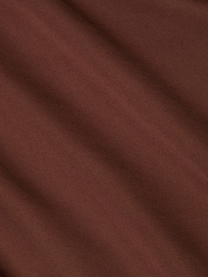 A close-up of the Akiya Satin Maxi Dress reveals smooth, brown bias-cut satin with soft diagonal folds and a subtle sheen, highlighting the luxurious texture of this evening essential.