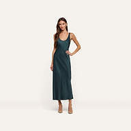 A person wears a forest green Akiya Satin Maxi Dress, a bias-cut style with a scoop neck, paired with tan heels.