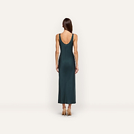 Back view of a person wearing the forest green, bias-cut satin Akiya Satin Maxi Dress with a scoop back and tan heels.